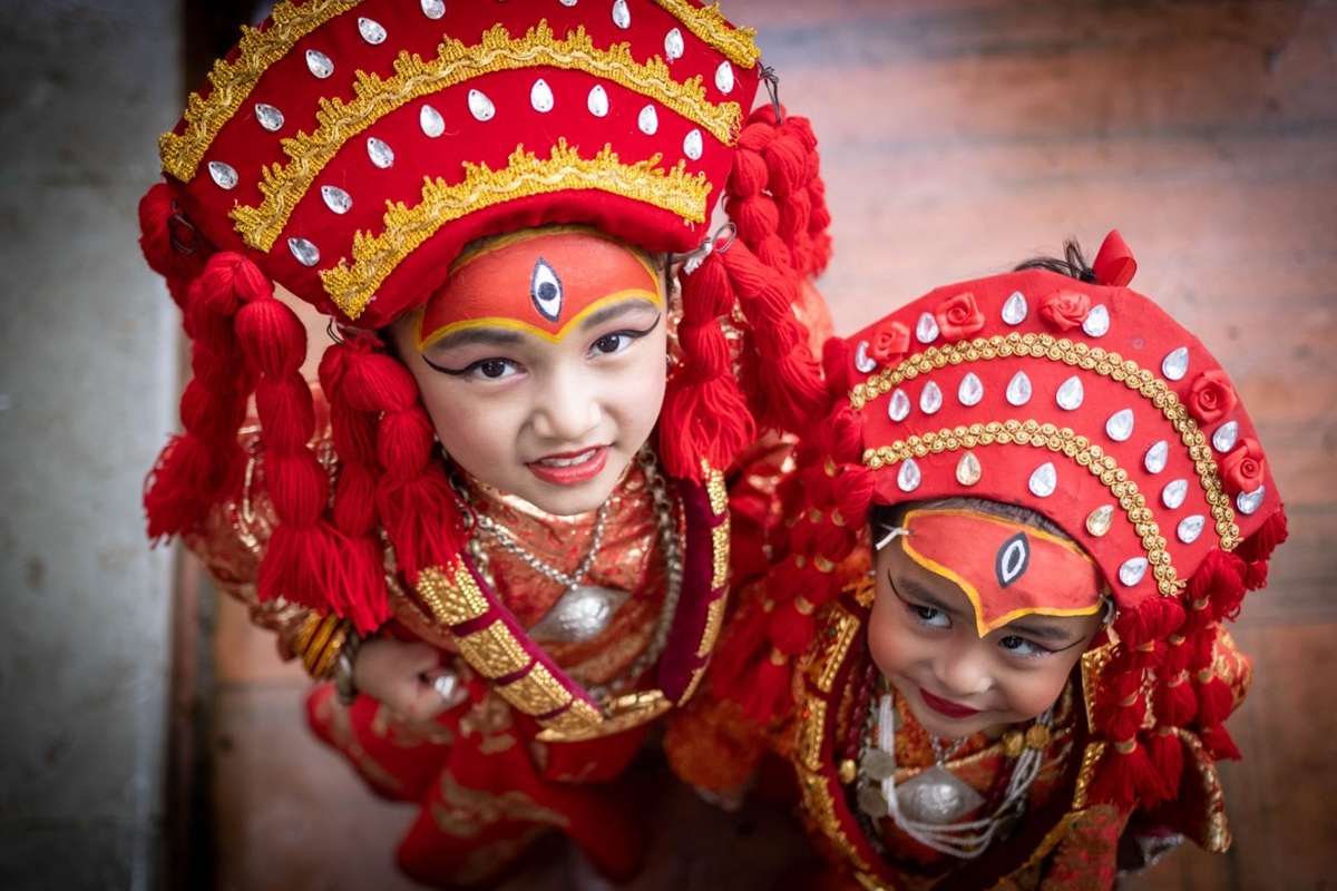 Beautiful Kumari Goddess of Nepal wearing traditional red attire and holy ornaments