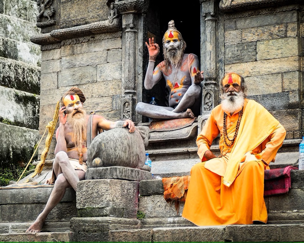 group of sadhus with painted faces and orange robes near pashupatinath temple