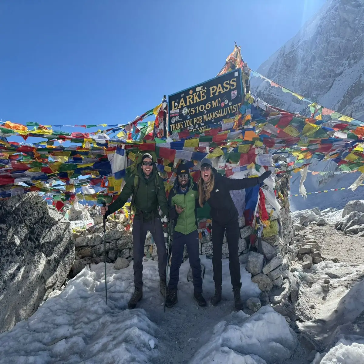 Trek over snowy trails to Larkya La Pass and descend